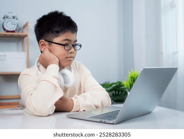 Educational of tech concept, Staying at home, Little Asian boy student using computer laptop learning.  Presenting a modern educational way of life. Virtual internet online class from school teacher.
 - Powered by Shutterstock