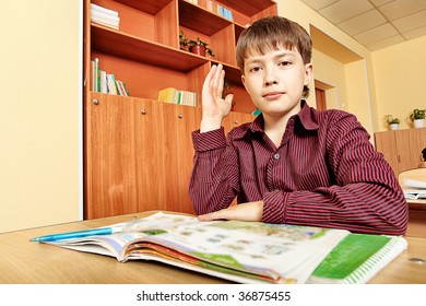 Educational theme: schoolboy in a classroom.