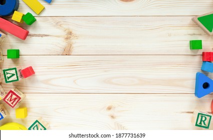 Educational toys blocks, numbers, letters on the wooden table. Toys for kindergarten, preschool, or daycare. Copy space for text. Top view - Shutterstock ID 1877731639
