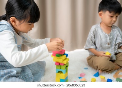 Educational toys for child,Cute little girl and boy are playing with toy building blocks at home.