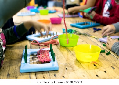 Educational weaving and knitting activity. Knitting wool for kids. 
