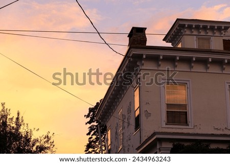 Edwardian Style House with peeling paint at sunset