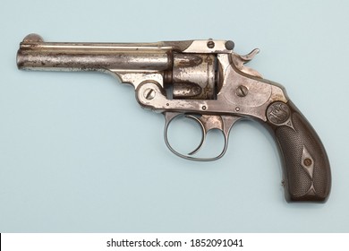 Edwardsville, IL-4/11/2016: Left side of well-worn Smith & Wesson Model 4 revolver made between 1883-1909. Top-break action, .32 S&W caliber, 5-shot, 3" barrel, nickel-plated, on blue background.