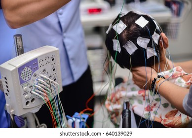 EEG electrode placement to patient during EEG record, Electroencephalogram (EEG)