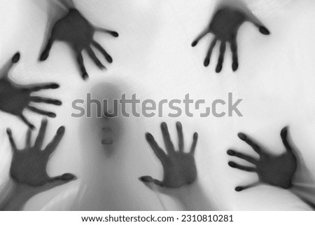 eerie blurry hands and face of people as if they have been trapped behind glass, dense fabric, wrap, ghost, spirit trying to reach out from afterlife, concept of violence, nightmares, halloween horror