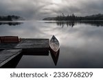 Eerie early morning mists on a calm lake