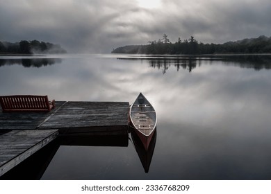 Eerie early morning mists on a calm lake