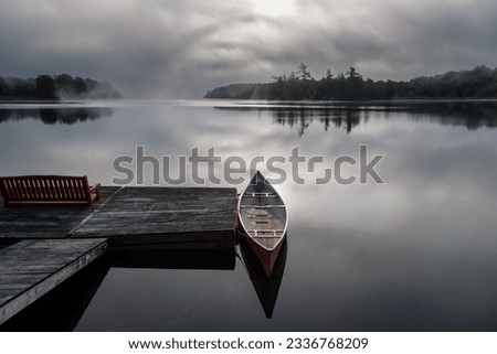 Eerie early morning mists on a calm lake