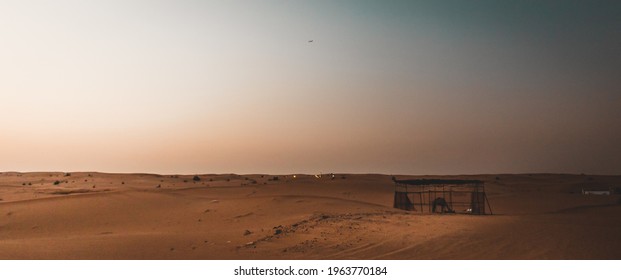 An Eerie Scenery Of A Desert At Dawn