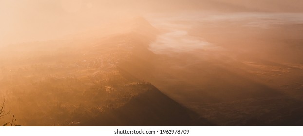 An Eerie Scenery Of Mountains In The Golden Haze