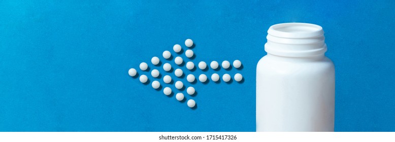 Effervescent Antacid Pills Coming From A White Tube Shaping An Arrow On Blue