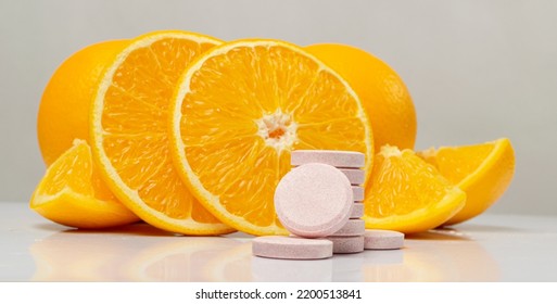 Effervescent Orange Tablets Pile. Fizzy Fruit Tablets, Disease Prevention Concept, Pink Orange Effervescent Vitamine Supplement Closeup