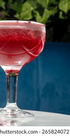 Effervescent ruby cocktail mingles with sunlight, enchanting serenity; perfect for Midsummer Eve or quirky urban gatherings