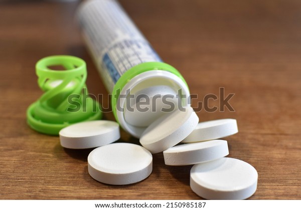 effervescent\
tablets vitamins on a brown wooden\
table
