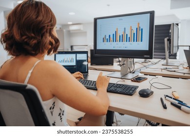 Efficient Female Professional Using Technology for Data Analysis and Sales Planning.