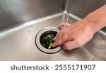 Efficient food waste disposal using a kitchen sink garbage disposer under running water