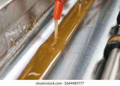 Efficient glue application process in action with a precision glue-spreading machine at a manufacturing facility