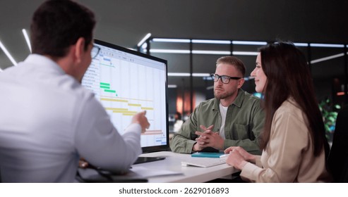 Efficient Hispanic Event Planner Organizing Busy Office Schedule Using Software.