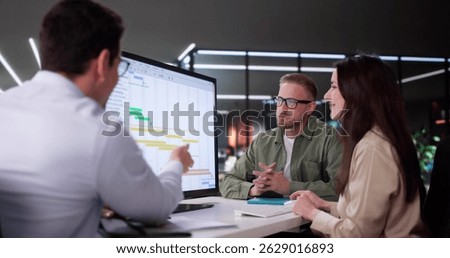 Efficient Hispanic Event Planner Organizing Busy Office Schedule Using Software.