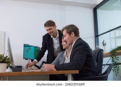 Efficient teamwork in modern office setting showcases collaboration and productivity. group of professionals engages with data on computer, highlighting analysis and strategy.