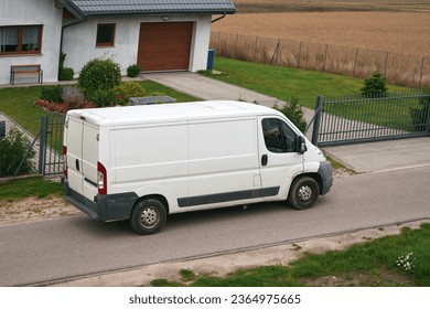 Efficient White Delivery Van on the Move. Modern Cargo Courier.  White Van Transporting Parcels on the Road