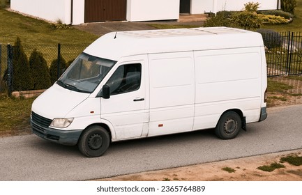 Efficient White Delivery Van on the Move. Modern Cargo Courier.  White Van Transporting Parcels on the Road