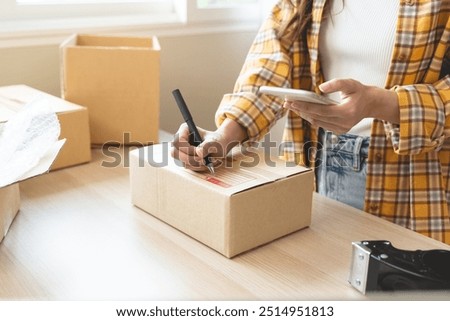 Efficiently preparing packages for seamless shipping. The hands of an online store meticulously pack and protect products, ensuring a smooth fulfillment process for satisfied customers worldwide.