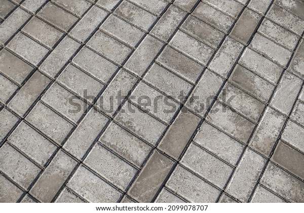 Efflorescence on gray paving slabs. Paving\
slabs on a construction site as a\
background