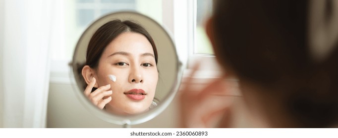 Effortless Elegance: A Serene Moment of Self-Care as a Woman Applies Luxurious Moisturizing Cream for Glowing, Nourished Skin and Unveils the Beauty of Skincare Rituals - Shutterstock ID 2360060893