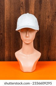 Effortlessly stylish, a white blank hat worn by a fashion head doll is featured in this captivating mockup image - Shutterstock ID 2336609295