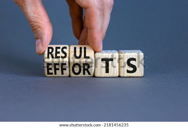 Efforts\
and results symbol. Concept words Efforts and results on wooden\
cubes. Businessman hand. Beautiful grey table grey background.\
Business efforts and results concept. Copy\
space.