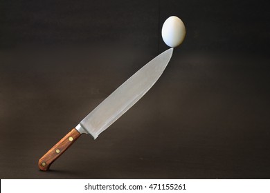 Egg Balanced On Chef's Knife