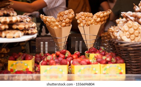 egg bubble waffles wrapped by brown paper in a basket as street food