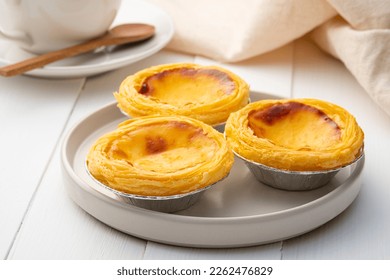 Egg custard tart dessert on white plate ,traditional Portuguese dessert ,sweet food