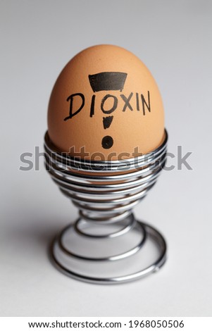 Egg with dioxin pollution on white background