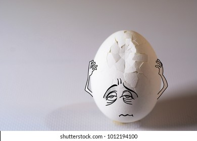 Egg with headache, problem and pain, his aching head covered by hands