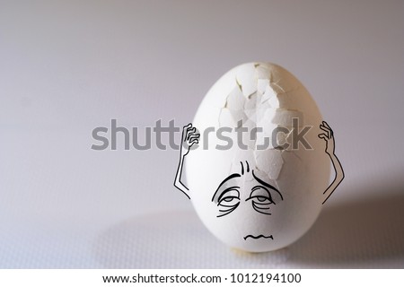 Egg with headache, problem and pain, his aching head covered by hands