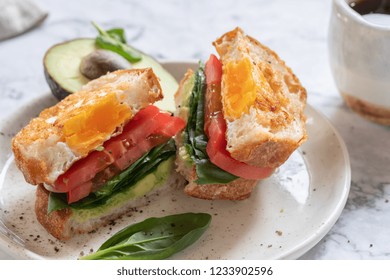 Egg In A Hole Sandwich With Avocado, Spinach And Tomato For Breakfast