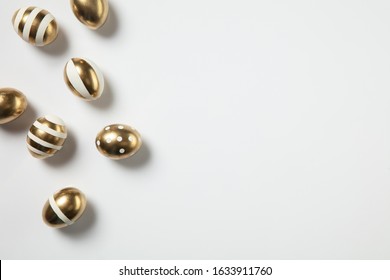 Egg Hunt Is Coming. Easter Traditions, Golden Colored Eggs On White Background, Top View, Copyspace For Your Ad Or Greetings. Concept Of Holidays, Spring, Celebrating, Food And Sweets, Family Time.