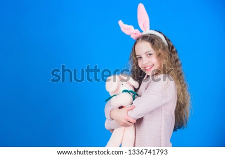 Egg hunt. Family holiday. Spring party. Little girl with hare toy. Happy easter. Child in rabbit bunny ears. copy space.h appy small child. small child with toy. Child with small toy hare. Happy day.