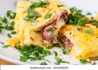 Egg omelette with ham and cheese with chive, closeup.