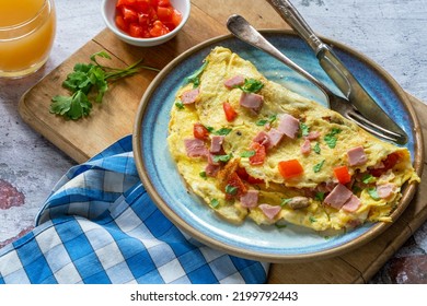 Egg omelette with ham, mushrooms and tomatoes