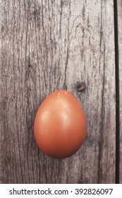 Egg on wood background - Shutterstock ID 392826097