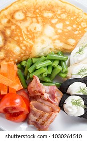 egg pancake with vegetables and ham slices