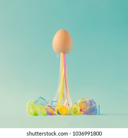 Egg With Party Streamers. Easter Minimal Concept.