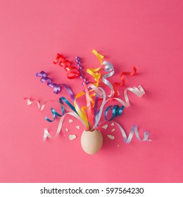 Egg With Party Streamers On Pink Background. Easter Concept. Flat Lay.