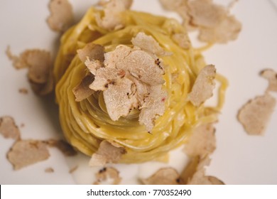Egg pasta dish, typical Italian, with fine white truffle grated on top. Concept of: gourmet cuisine, truffles, Italian pasta, fine dishes.