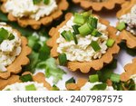 Egg paste cupcake. Egg spread tartlets. Boiles eggs with mayo on baked tarta cake sprinkled with chives onion spring. Salty party snack. Eggs salad on tartlet.