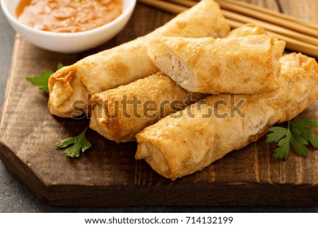 Egg rolls with cabbage and chicken on a wooden board