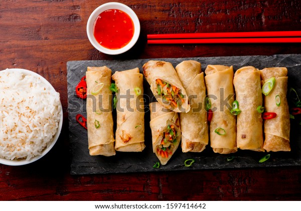 Egg rolls or spring rolls fried.Traditional Chinese Thai\
restaurant appetizer, spring rolls or egg rolls. Made from wonton\
wrappers and filled with Chinese veggies and served w/ chili\
dipping sauce. 
